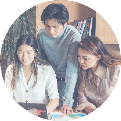 Three colleagues working together on a project in an office setting