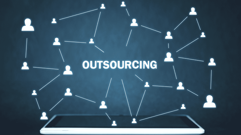A digital concept of outsourcing, with interconnected human icons linked by lines and the word "Outsourcing" in the center, displayed on a dark background above a tablet.