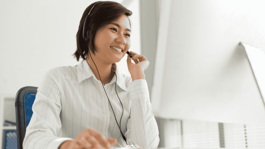 Customer service representative smiling while providing real-time multilingual customer service.
