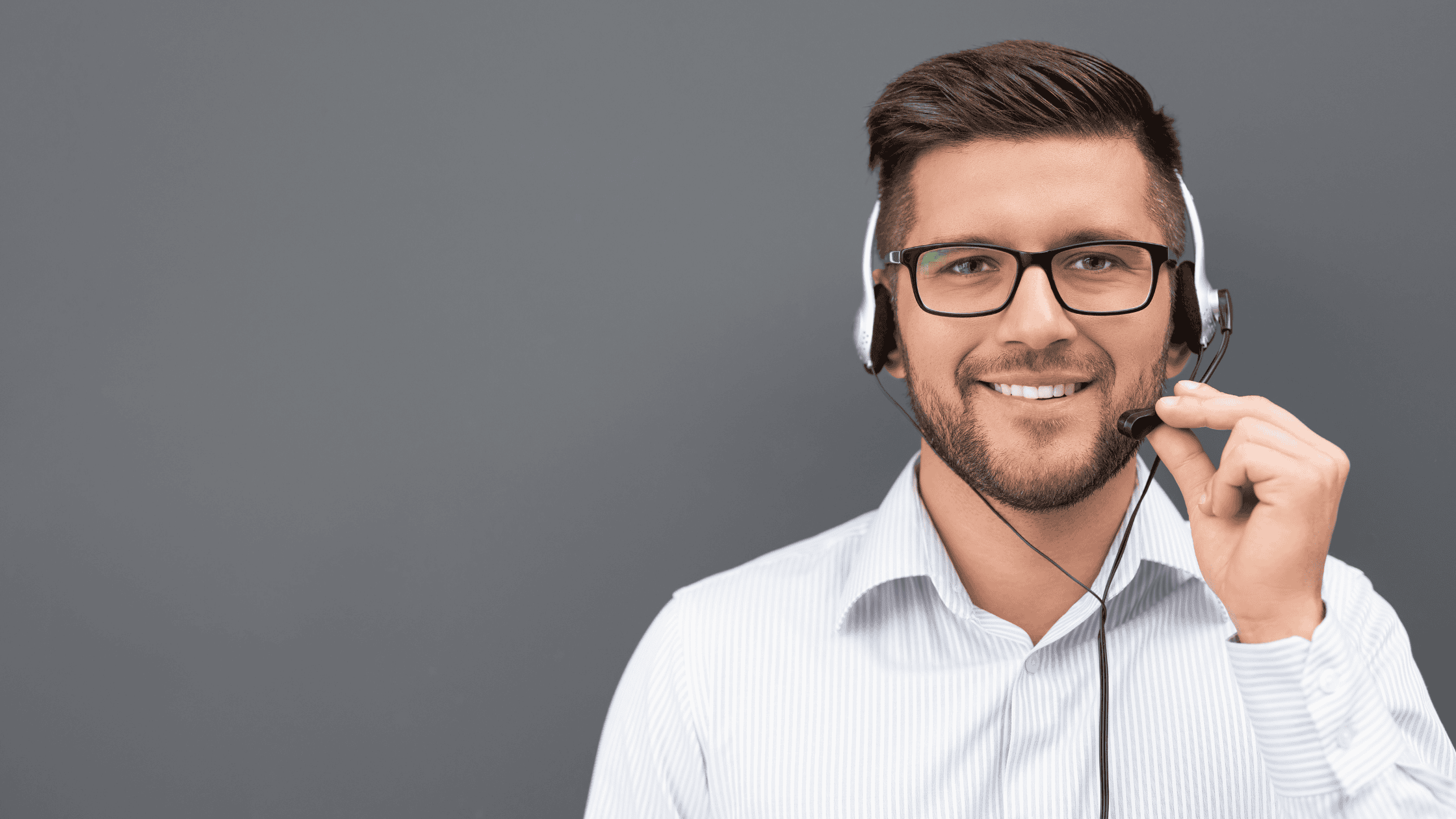 A smiling male customer service agent wearing a headset, ready to assist customers
