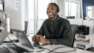 A professional providing continuous multilingual customer care, smiling while engaging in a virtual meeting.