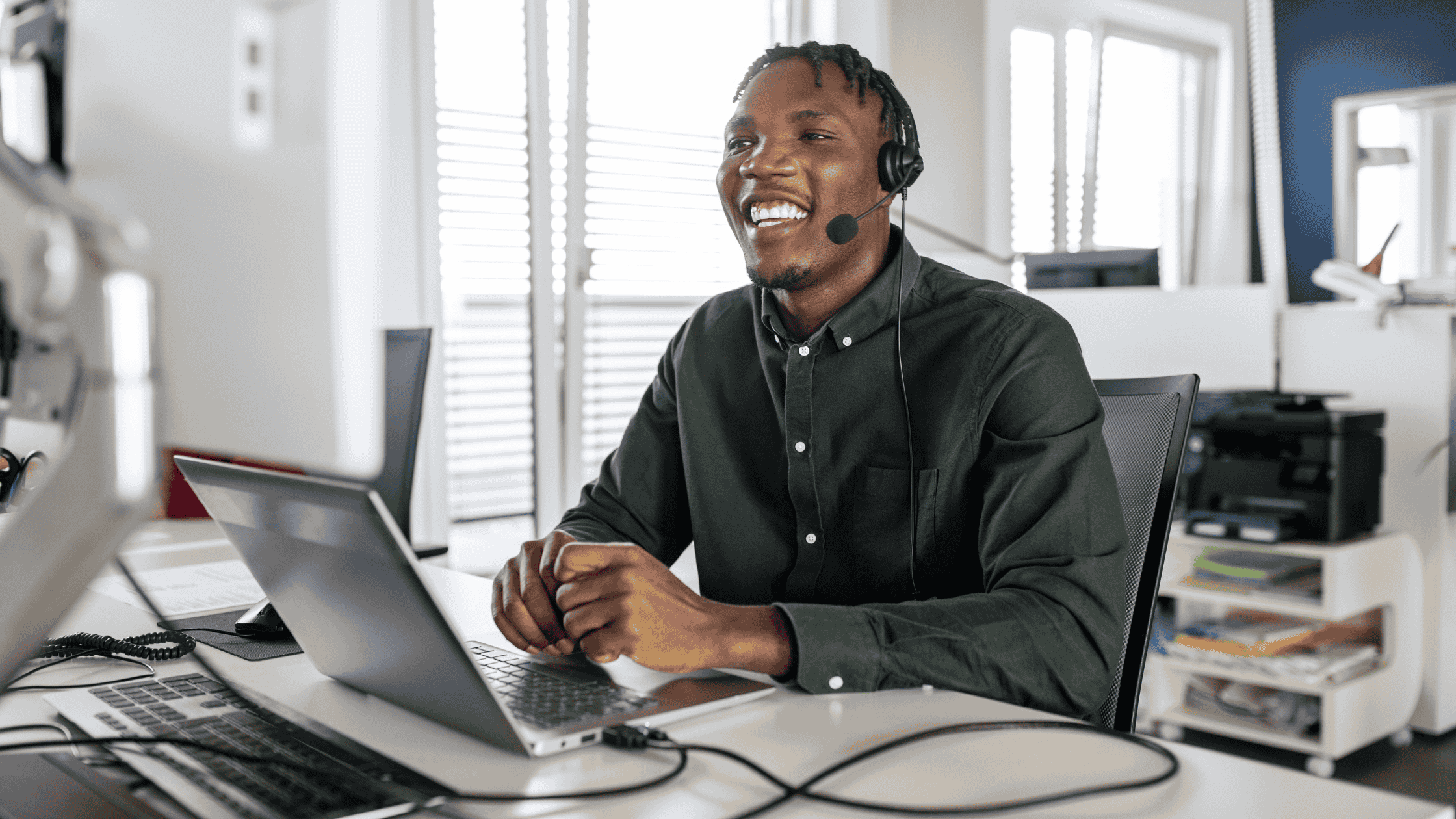 A professional providing continuous multilingual customer care, smiling while engaging in a virtual meeting.