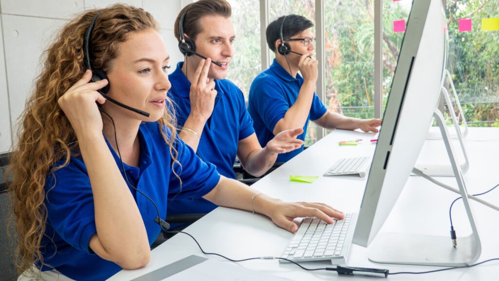 A dedicated customer support team providing multilingual phone support 24/7 at a modern call center.