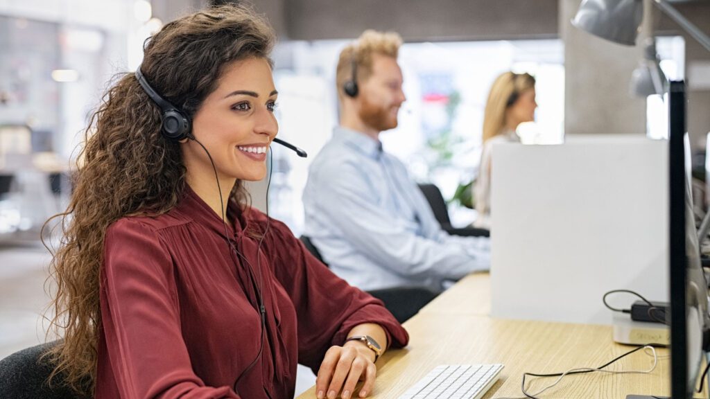 Multilingual customer support specialist offering 24/7 global language support services in a contemporary office setting.