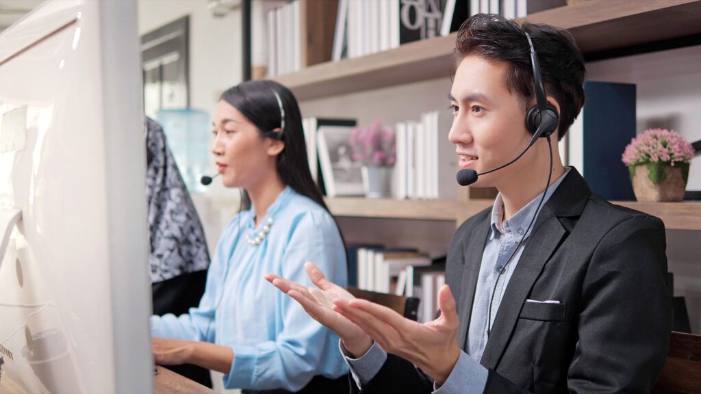 A dedicated customer support agent delivering nonstop multilingual technical support in a modern office setting.