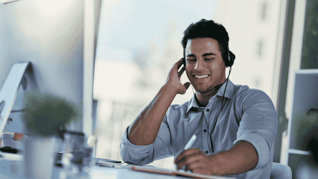 Customer support agent providing 24/7 multilingual support to customers in a well-lit office environment.