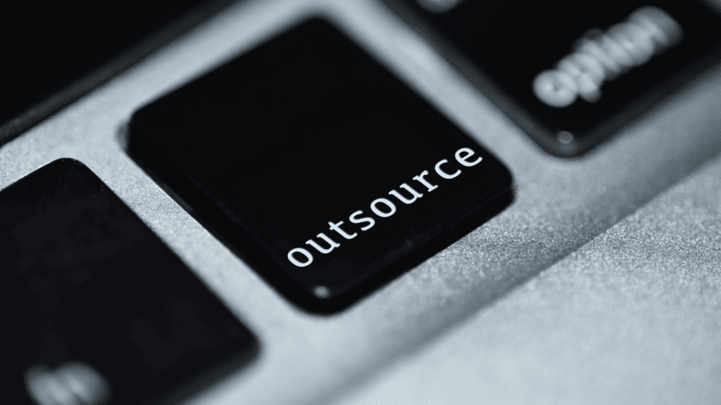 A close-up of a keyboard with a black "Outsource" key, symbolising business outsourcing solutions.