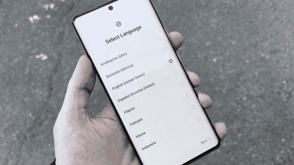 A close-up of a smartphone screen showing multiple language options for selection, including English, Spanish, French, and others.