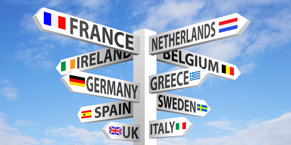 Directional signpost showing multiple European country names and flags, symbolising the multilingual workforce available in Malta’s customer service industry.