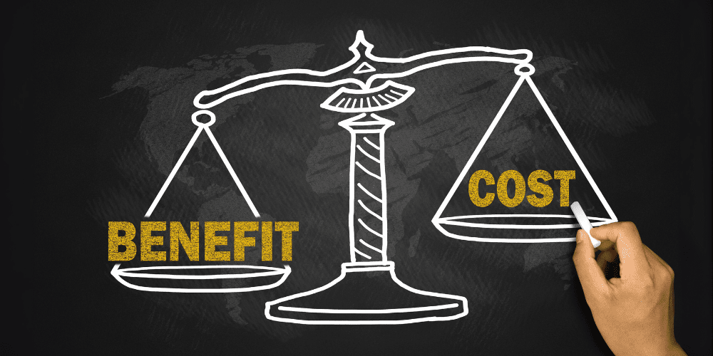 Hand drawing a chalk balance scale with the word ‘Benefit’ outweighing ‘Cost’ symbolising outsourcing value.