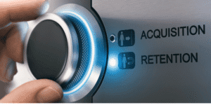 Hand turning dial from customer acquisition to customer retention.