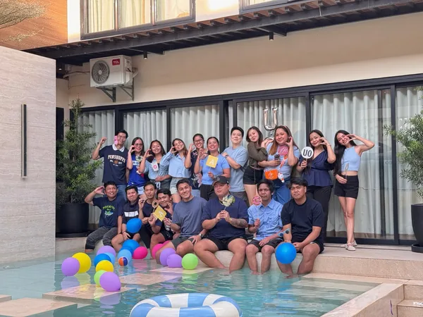 Manila customer service team enjoying a team building event by the pool
